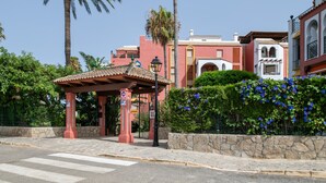 A street view with a red pavilion, palm trees, and buildings with traditional architecture. - Apartment 'Vistas Al Mar' with Sea View, Private Pool and Wi-Fi (Tarifa)
