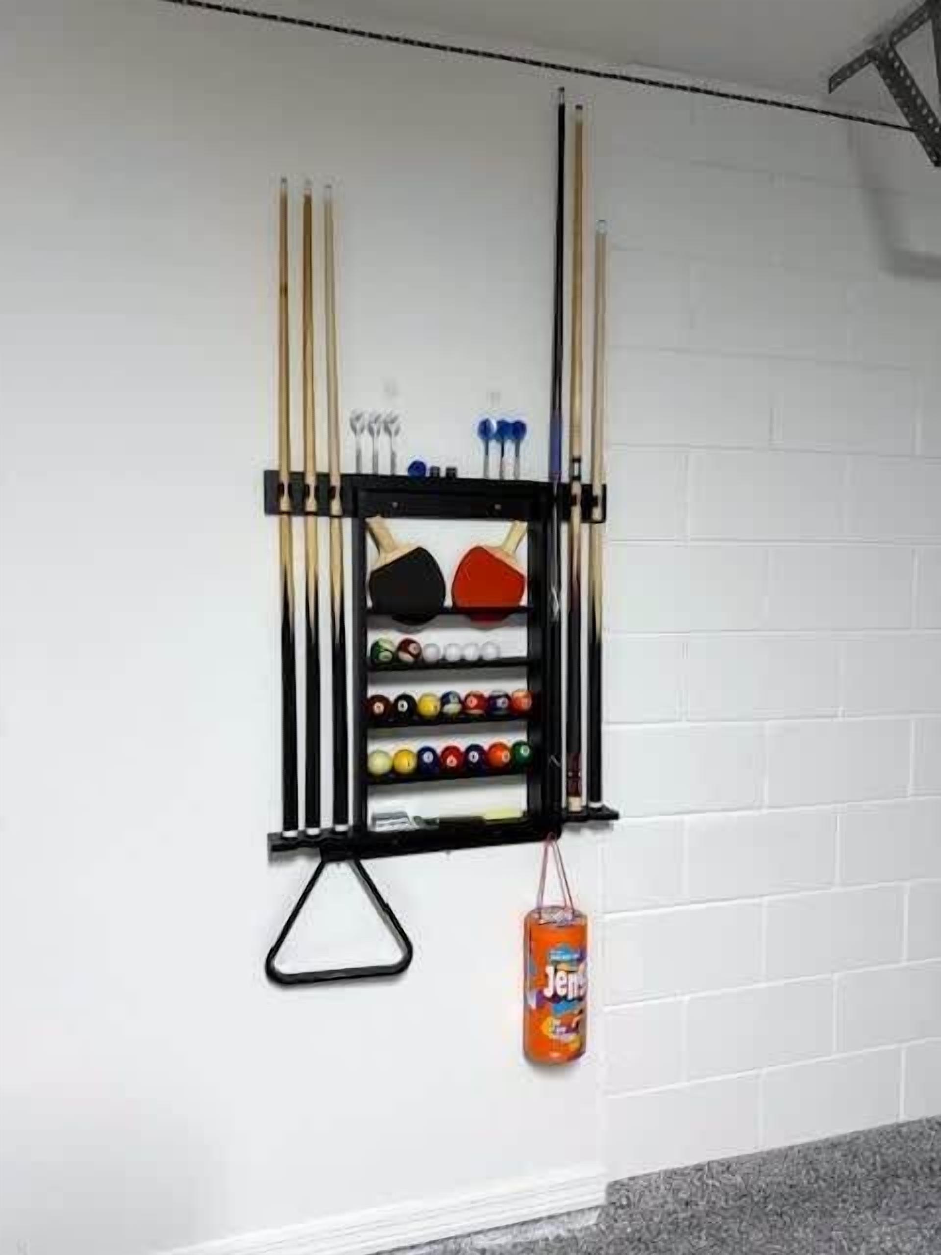 A wall-mounted rack holding pool cues, balls, and a bottle of Jergens lotion.