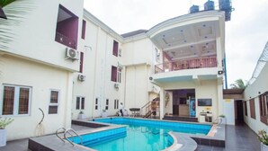 A residential building with a swimming pool, balconies, and a covered outdoor area. - Bromford Hotel (Owerri)