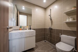 A modern bathroom with a marble sink, a toilet, and a shower. - LA Nest 2BR WeeklyMonthly big deal GH2 (Ho Chi Minh City)