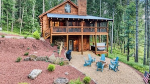 A log cabin with a two-story balcony, surrounded by a forest. - Whimsical Ways - Hot tub-screen porch-pet friendly (Blue Ridge)