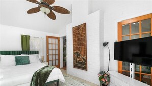 A bedroom with a bed, a ceiling fan, a TV, and a window. - Newly active beautiful 5-bedroom house in a prime location near DC (Arlington)