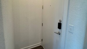 A narrow hallway with a white door and a carpeted floor. - Pleasant apartment in Austin (Leander)