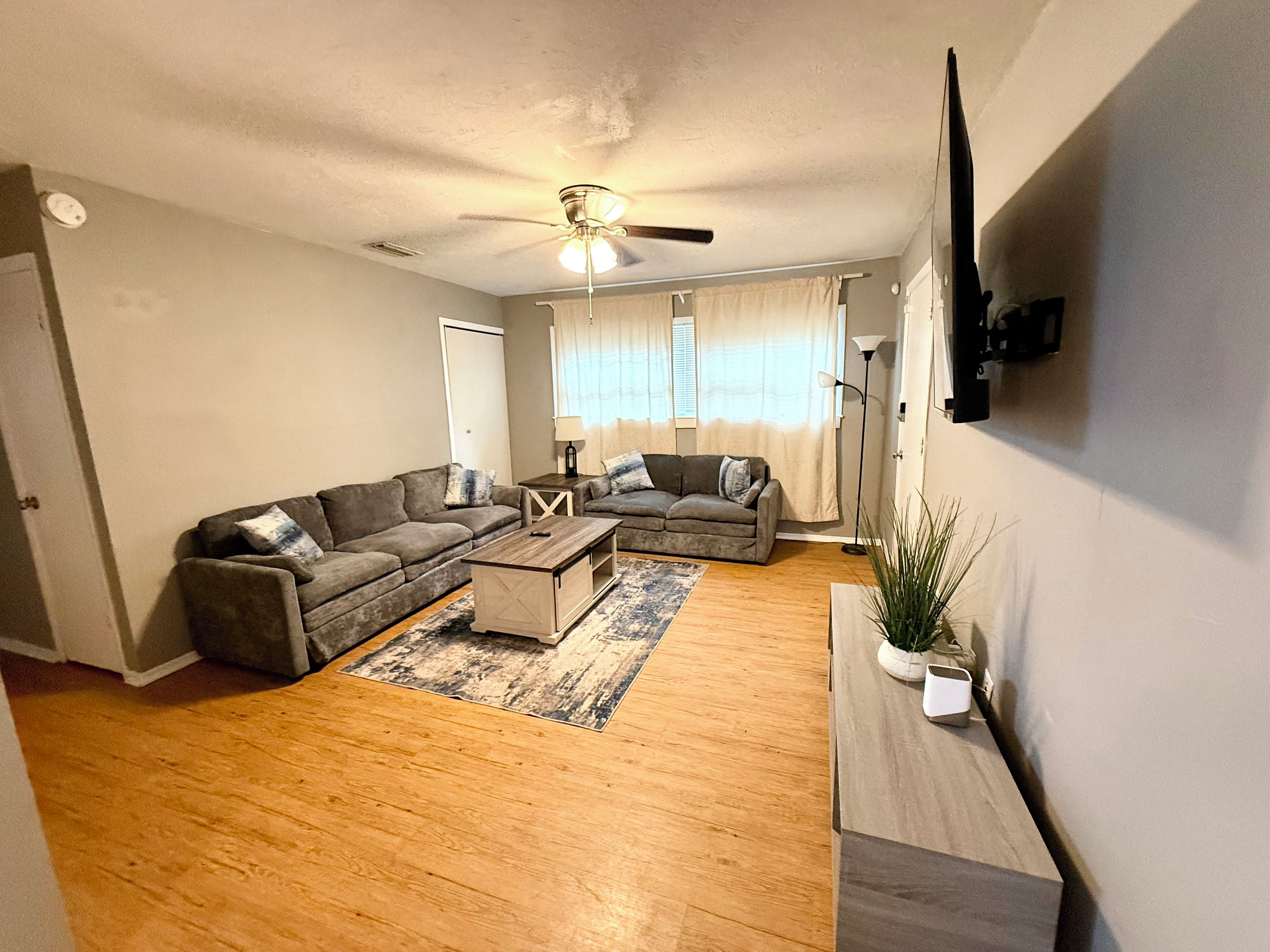 A living room with two sofas, a coffee table, and a floor lamp.