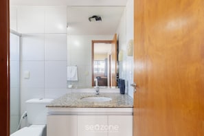 A modern bathroom with a granite countertop sink, white tiles, and a visible toilet. - Apt w/ Balcony 500m From the Beach - Eii0304 (Maceió)