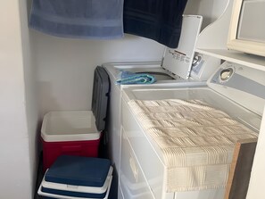 A laundry area with a washing machine, a dryer, and a stacked washer-dryer unit. - GRAN PACIFICO, OCEANFRONT CONDOMINIUM, MANZANILLO (Manzanillo)