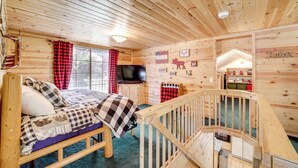 A wooden cabin interior with a bed, a television, and a staircase. - Hike + Snow Play! Payson Cabin By Mogollon Rim (Payson)