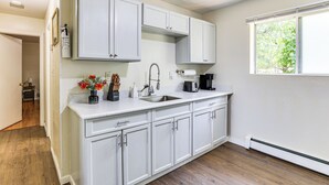 A kitchen with white cabinets, a sink, and a window. - 2 Mi to The Marketplace: Spring Valley Apartment (Spring Valley)