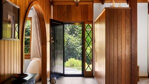 A wooden interior hallway with a door leading to an outdoor area. - Amber Wisper—In the Hills with Pool & Tennis Court (Paechtown)