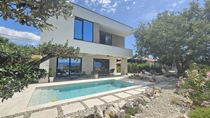 A modern two-story house with a swimming pool, outdoor seating, and a garden. - Holiday house VILLA AMORA with private pool (Linardići)