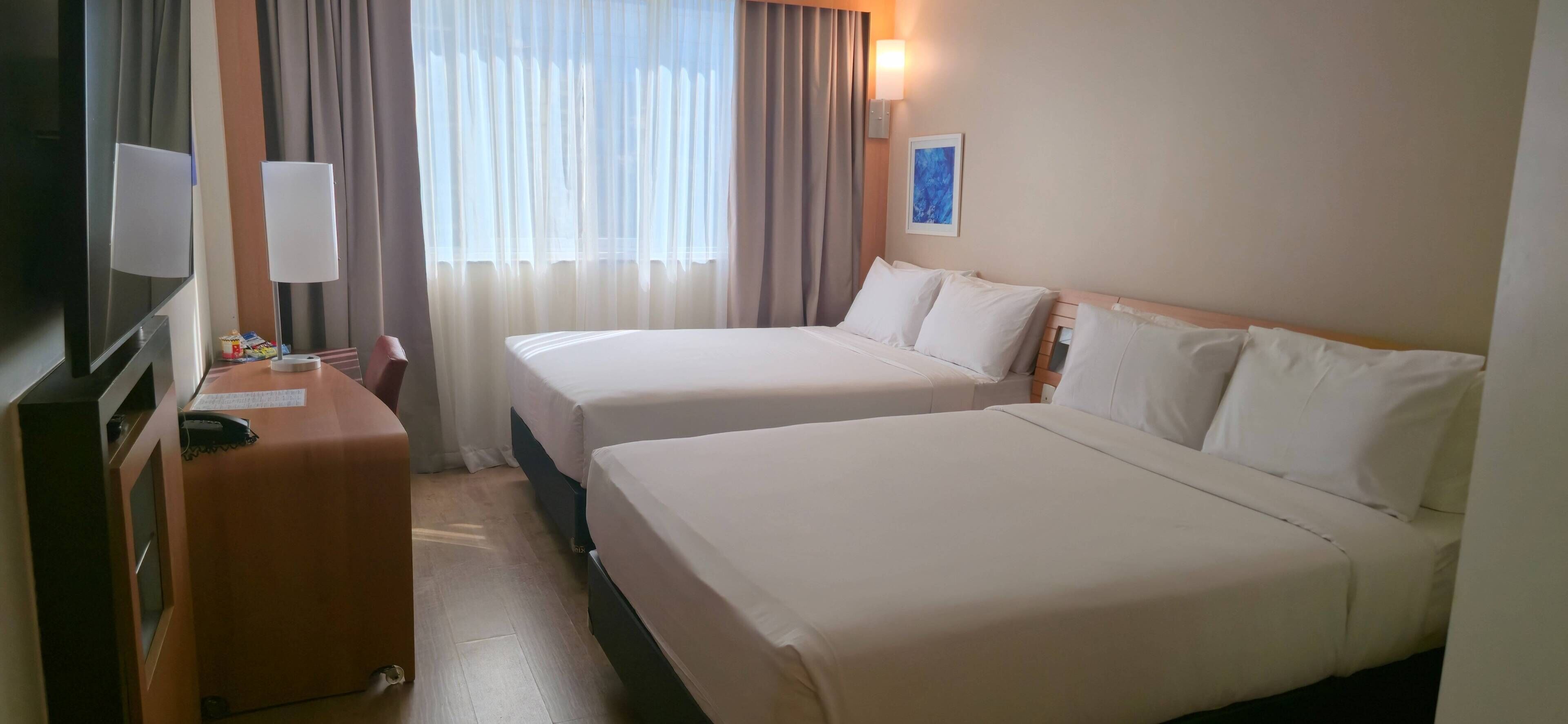 Family Quadruple Room, Partial Sea View | Minibar, in-room safe, desk, laptop workspace