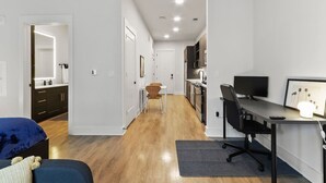A modern apartment with a living area, a kitchen, and a dining space.