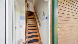 A wooden staircase leading to a room with a 'Welcome' sign and a small flag. - Stunning home in Kenz Küstrow (Kenz Küstrow)