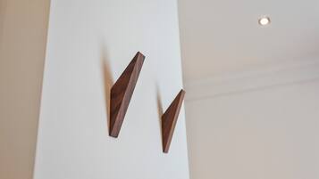 A white wall with two wooden wall-mounted light fixtures.