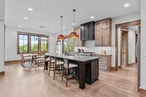 Oven, coffee/tea maker, cookware/dishes/utensils, dining tables