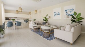 A modern living room with a sofa, chairs, a coffee table, and a dining area with chairs and a table. - Luxury 3 BR apartment with terrace, pool & gym (La cala de mijas)