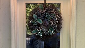 A white door with a glass panel, a wreath, and a black doorbell. - Quaint and quiet retreat close to beach (Victoria)