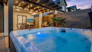 A hot tub in a backyard with a covered patio, a barbecue grill, and a dining area. - Skyline 1634, Private Swim Spa & Hot Tub (Washington)