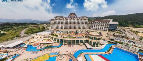 A large hotel with multiple swimming pools, a central courtyard, and a variety of amenities.