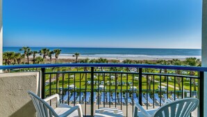 A balcony with a view of the beach, rows of sun loungers, and a clear blue sky. - Spacious Beach Condo Double Suite for Couples Getaway (Myrtle Beach)