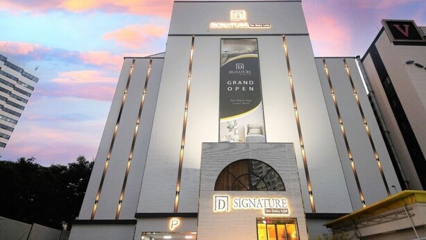 A modern hotel building with a prominent 'Signature' sign and a 'Grand Open' banner. - Signature Denbasta Hotel (Busan)
