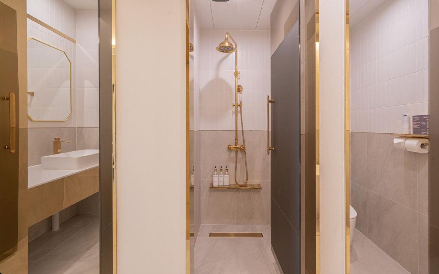 A modern bathroom with a shower, toilet, and vanity.