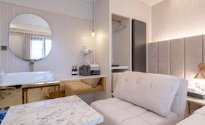A modern bathroom with a large mirror, a white sink, and a towel rack. - Signature Denbasta Hotel (Busan)