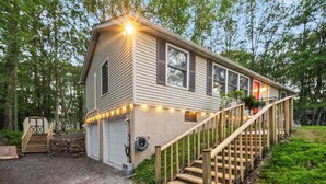 A single-story house with a front porch, a staircase, and a garage.