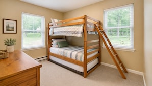 A bunk bed with a ladder, a desk, a potted plant, and a framed picture on the wall. - Serenity Cottage Deck, Game Room & Fire Pit near Narrowsburg Masthope (Lackawaxen)