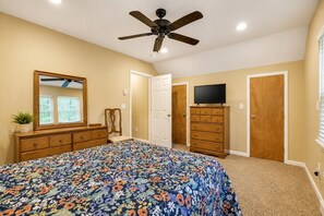 A bedroom with a bed, dresser, television, and ceiling fan. - Serenity Cottage Deck, Game Room & Fire Pit near Narrowsburg Masthope (Lackawaxen)