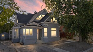 A two-story house with a front porch, a garage, and a driveway.