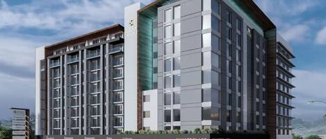 A modern multi-story hotel with a prominent 'Hyatt Place' sign, featuring a ground-level restaurant and cafe area with outdoor seating.