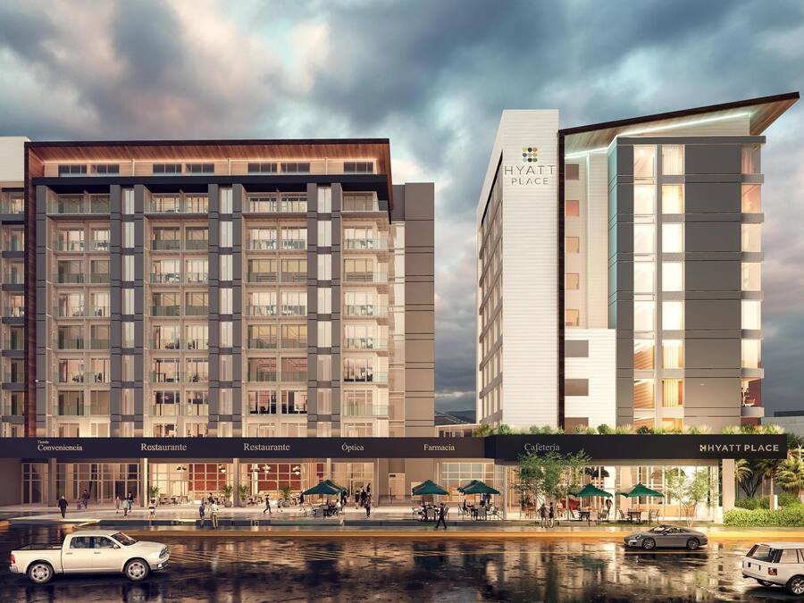 A modern hotel with multiple floors, featuring amenities such as a restaurant, pharmacy, and convenience store.