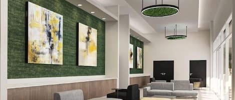 A modern lobby with a green textured wall, abstract paintings, and contemporary furniture.