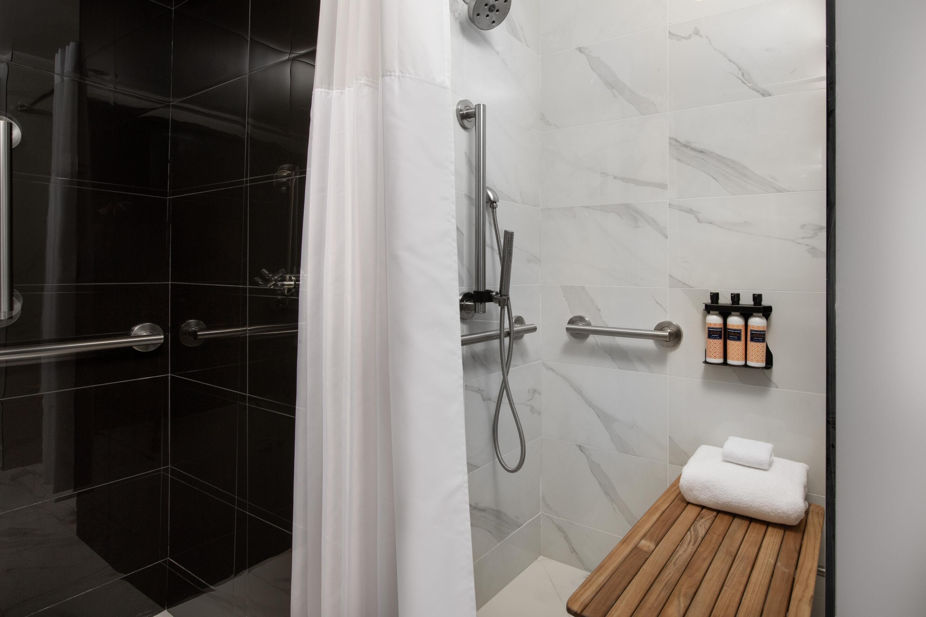 Deluxe Room, 1 King Bed, Roll-in Shower | Bathroom | Shower, rainfall showerhead, eco-friendly toiletries, hair dryer