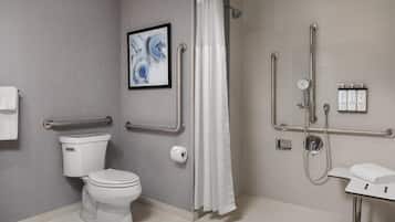 Un baño moderno con inodoro, ducha y lavamanos.