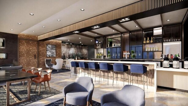A modern bar area with a long counter, bar stools, and a variety of bottles and glasses. - Hyatt Place Toronto Airport (TORONTO)