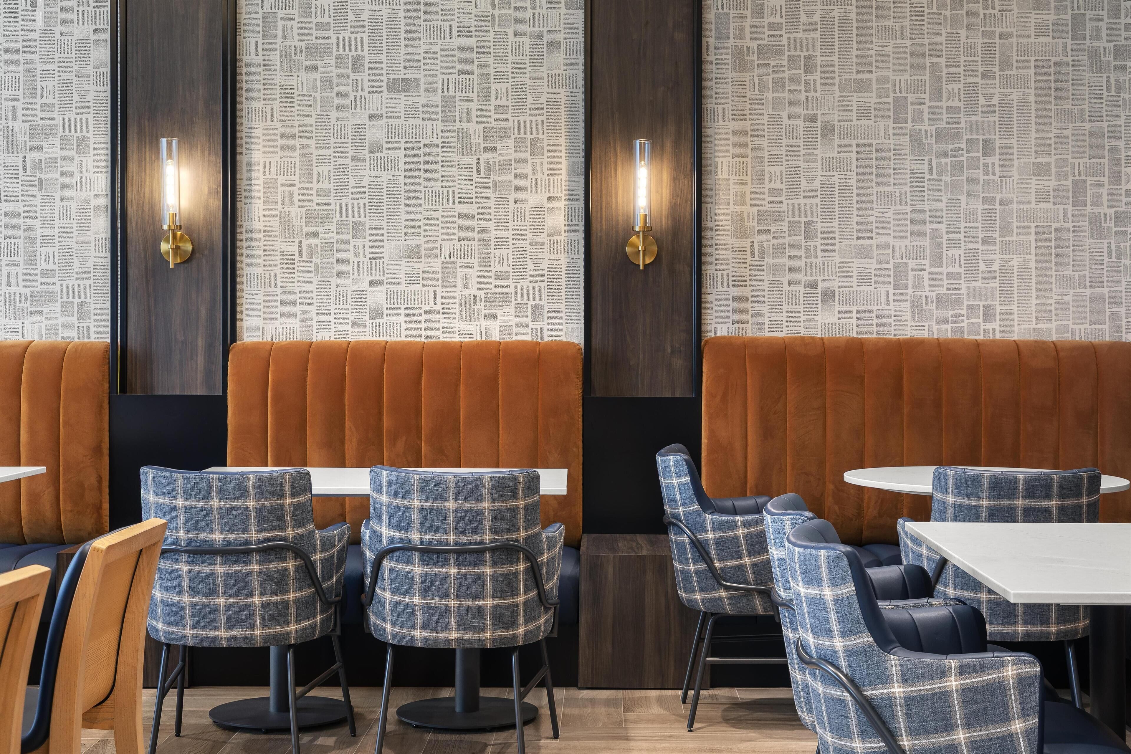 A restaurant interior with booths, tables, and modern decor.