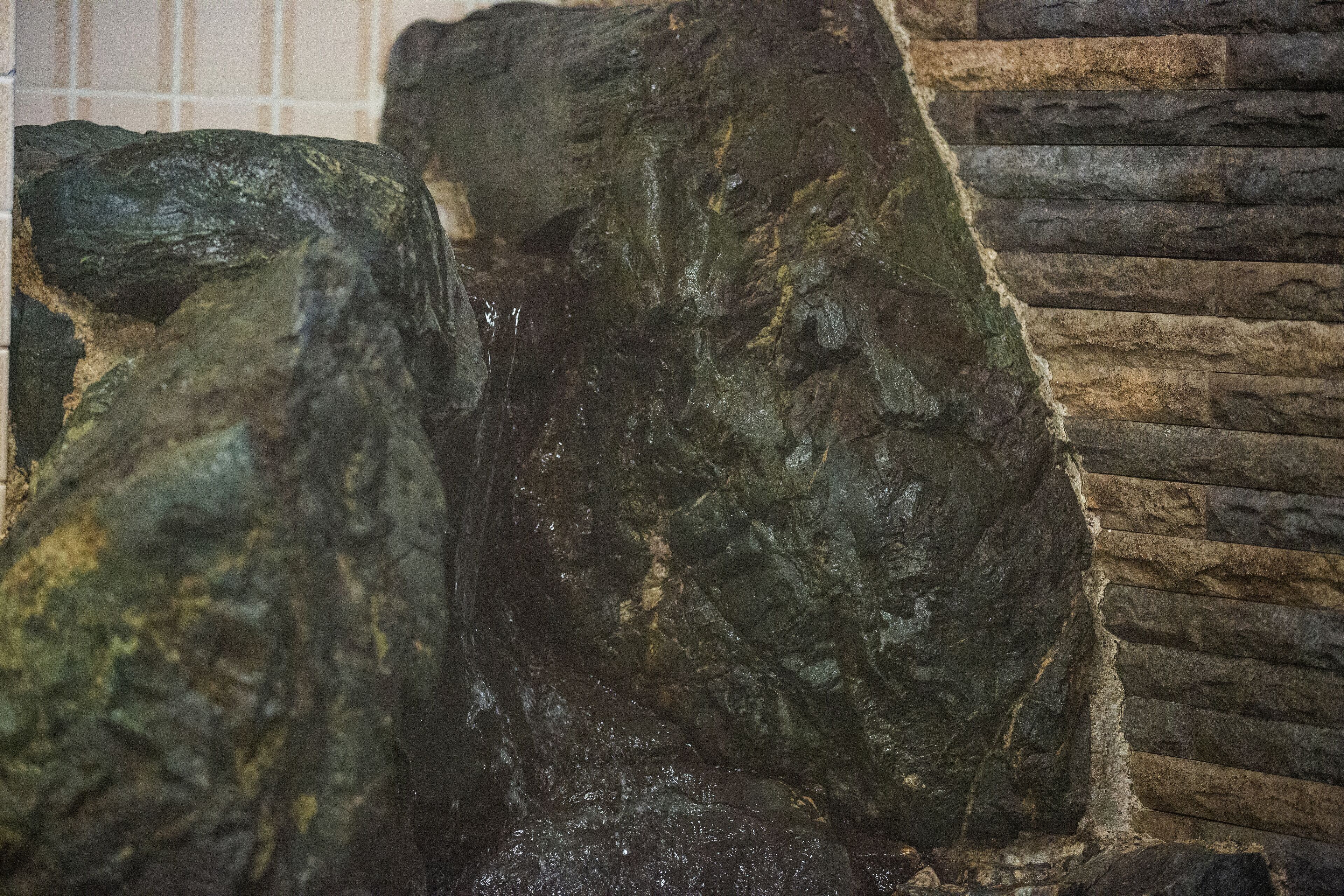 A rock formation with a small waterfall.