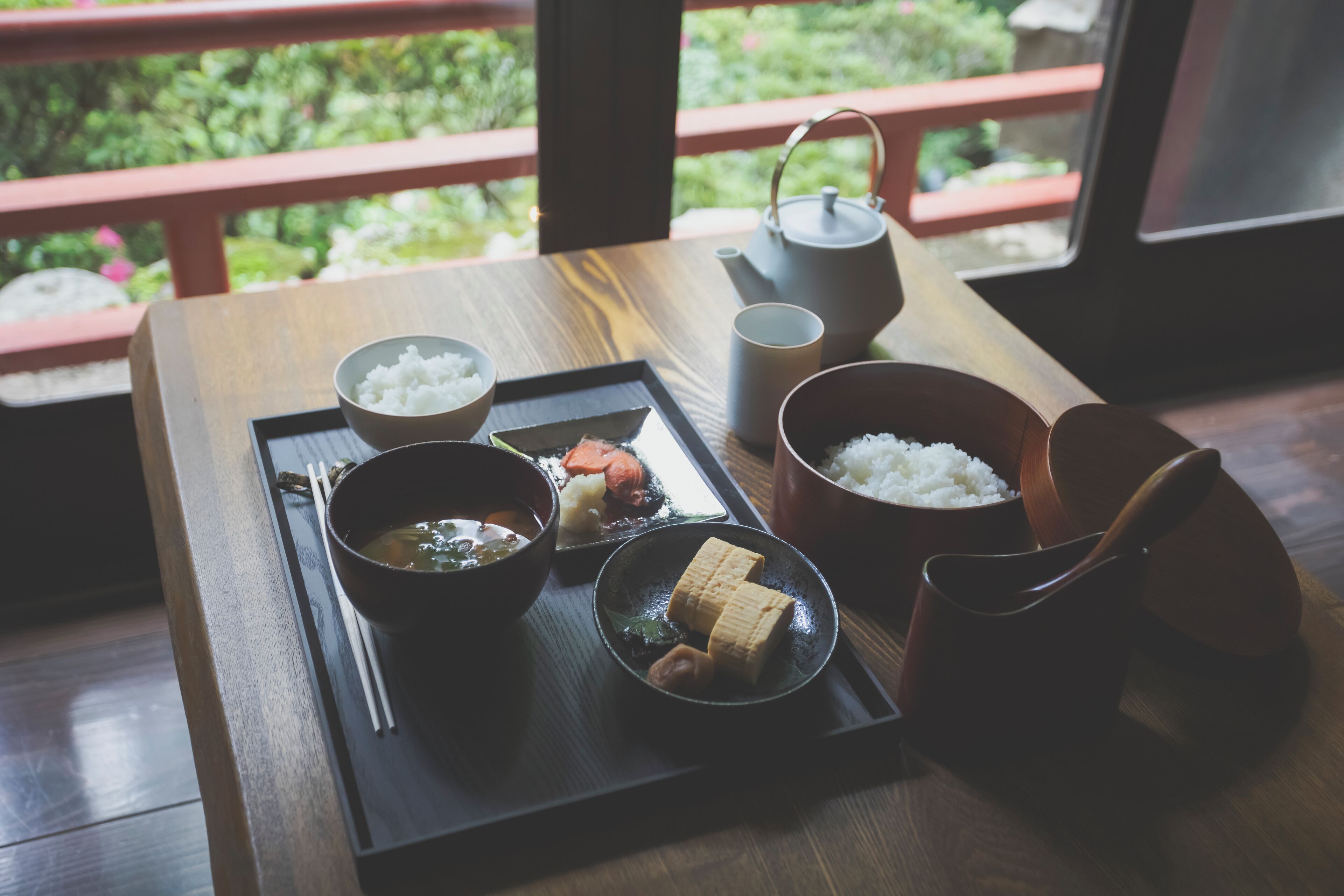 A tray with various Japanese dishes including rice, soup, and pickled vegetables.
