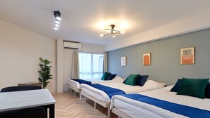 A hotel room with three single beds, a desk, and a chair. - XS41 XROSS STAY Juso1 (大阪市淀川区十三東)