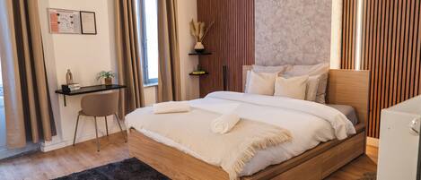 Habitación básica | Espacio para trabajar con un portátil y tabla de planchar con plancha