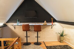 Espacio para trabajar con laptop y tabla de planchar con plancha 