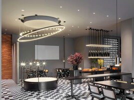 A modern interior with a checkered floor, round tables, and contemporary lighting fixtures.