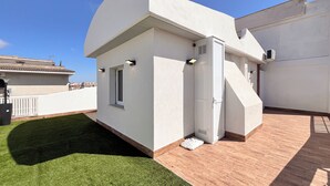 A modern building with a white exterior, a small window, and a door. - Tiny Loft Skydeck (Civitavecchia)