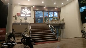 A hotel entrance with a staircase leading to the lobby. - Hotel The Castle Inn (Varanasi)