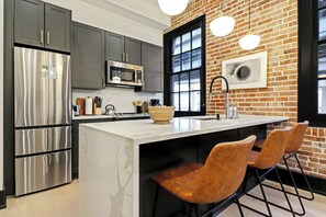 Fridge, stovetop, dishwasher, coffee/tea maker