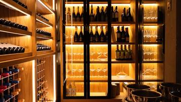 A wine cellar with wooden shelves and glassware.