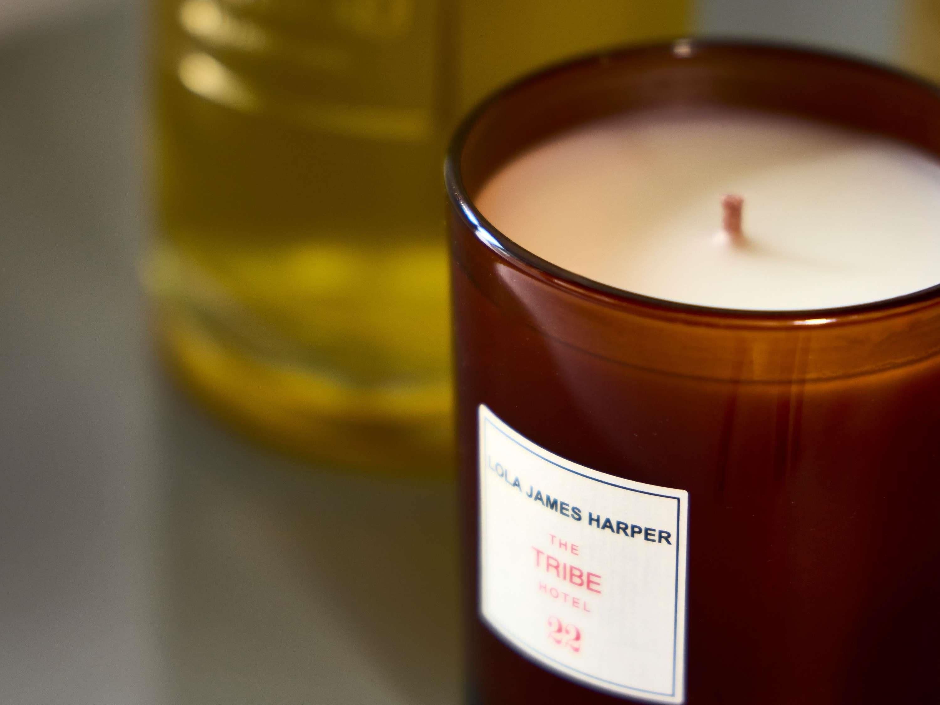 A candle labeled 'The Tribe Hotel' by James Harper.