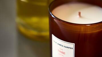 A candle labeled 'The Tribe Hotel' by James Harper.
